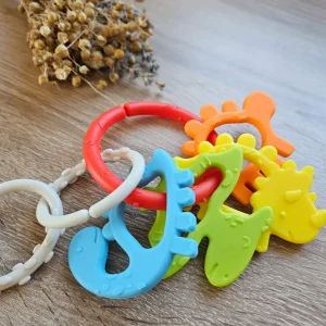Greifling Dino "bunt" — Millhouse Lernspielzeug Schule